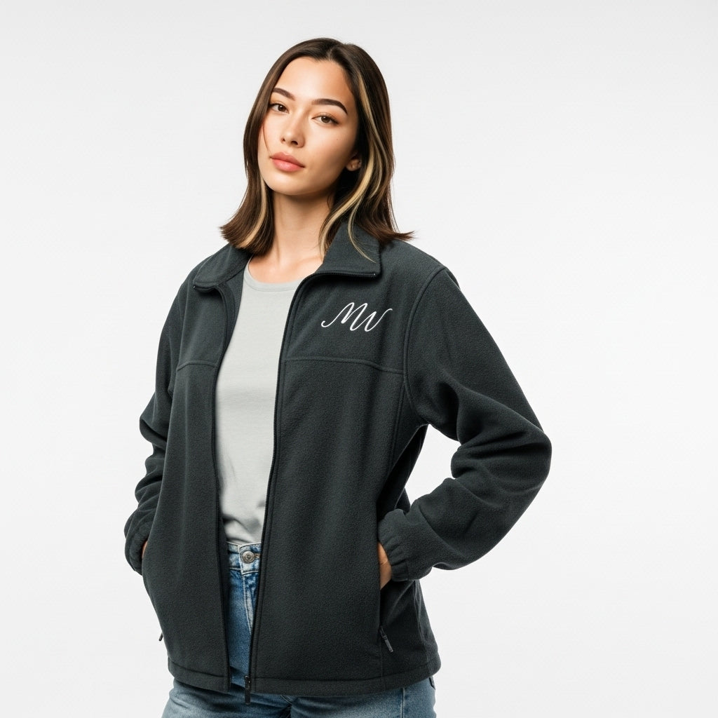 Woman wearing a dark gray jacket with 'MT' logo on a white background