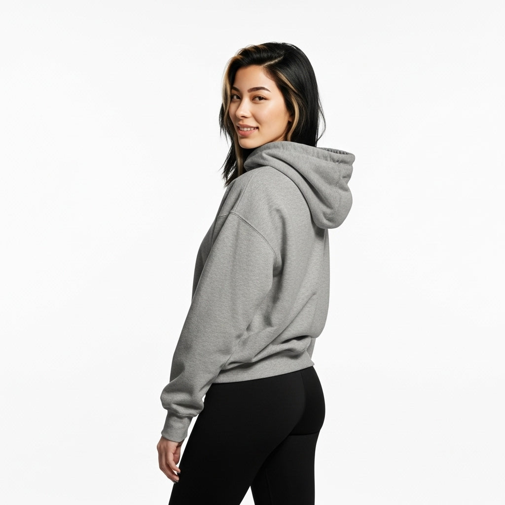 Woman wearing a gray hoodie on a white background