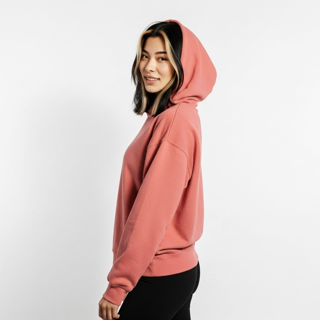 Person wearing a pink hoodie on a white background